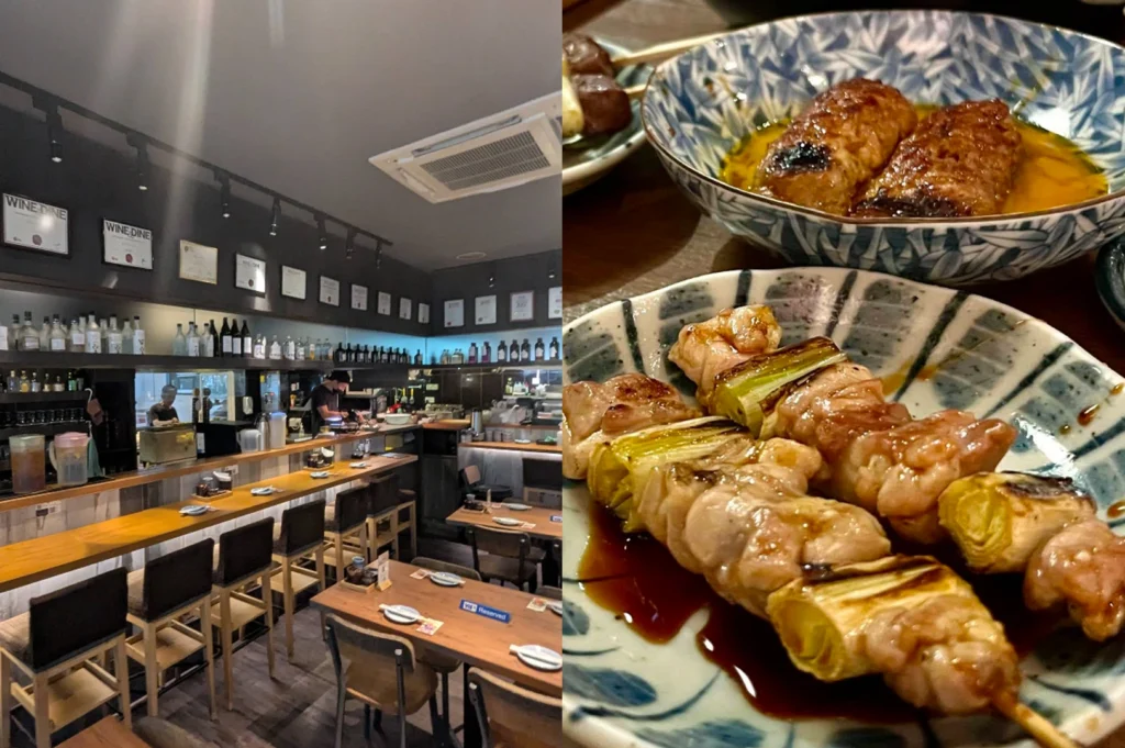 A composite image, the left panel presents an elevated view of a modern Japanese restaurant interior featuring a long, wooden bar counter lined with several high-backed chairs facing an open kitchen. Framed certificates reading "WINE & DINE" and other accolades are mounted in a row above shelves stocked with numerous bottles of sake and other beverages. Two kitchen staff are visible working behind the counter, while a few lower tables set with chopsticks and small plates fill the foreground. The right panel is a close-up of a rustic, hand-painted ceramic plate holding three grilled skewers of chicken thigh and scallion, coated in a glistening, dark savory tare sauce and garnished with chopped green onions. Above and to the right, another bowl in the background contains two rounded tsukune, or ground chicken meatballs, covered in sauce.