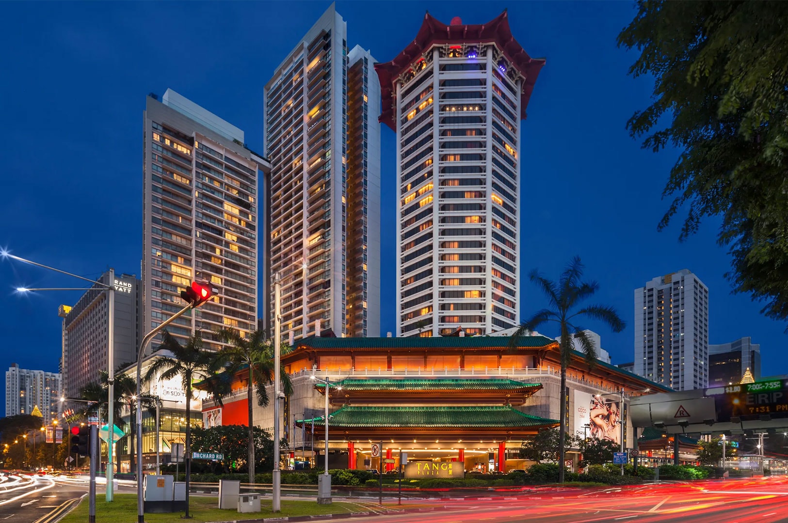 Night view of the iconic Singapore Marriott Tang Plaza Hotel featuring its distinctive octagonal pagoda-style roof and illuminated architecture on Orchard Road.