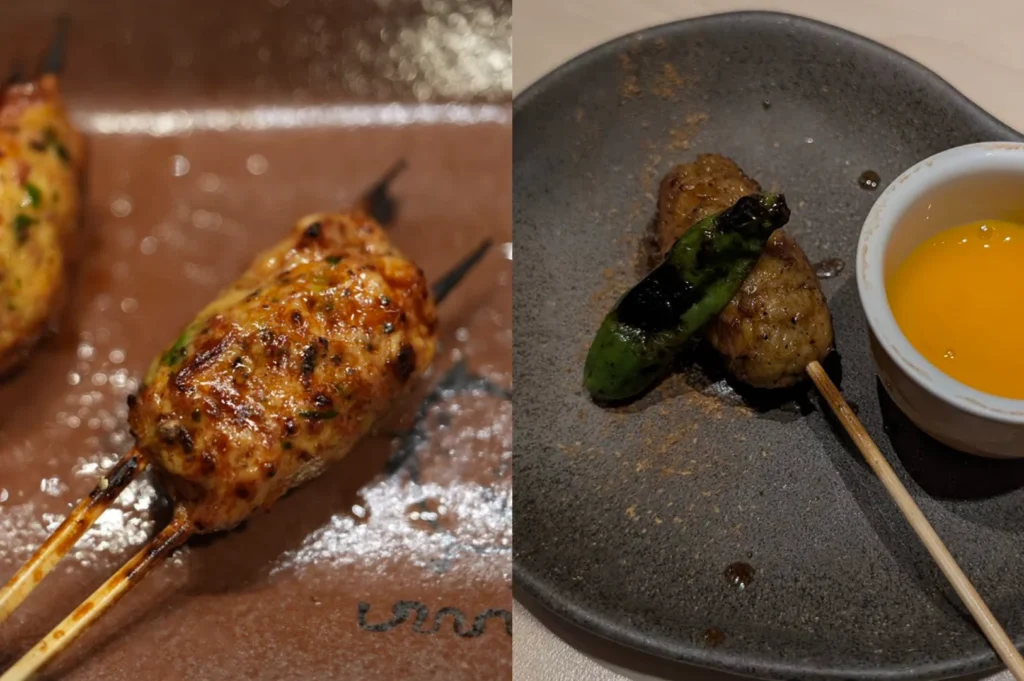 This comparison focuses on tsukune, or minced chicken skewers. The left side shows a close-up of a large, oblong chicken meatball with a glossy, caramelized exterior and visible flecks of herbs, resting on a brown ceramic plate. The right image shows a smaller, more rounded tsukune skewer served on a dark grey plate. It is garnished with a single charred green shishito pepper and served alongside a small white ramekin containing a bright, deep orange raw egg yolk for dipping.
