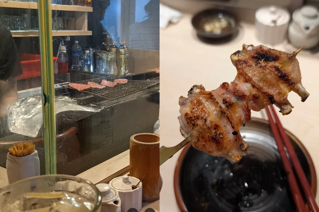 This split-screen image presents a diner's perspective: on the left, the view from behind a wooden counter looks through a glass partition at thin slices of meat grilling on a wire rack; on the right, a skewer of crispy, blistered chicken wings is held up in a close-up, showing off the perfectly browned skin against a blurred background of a dining table with red chopsticks.