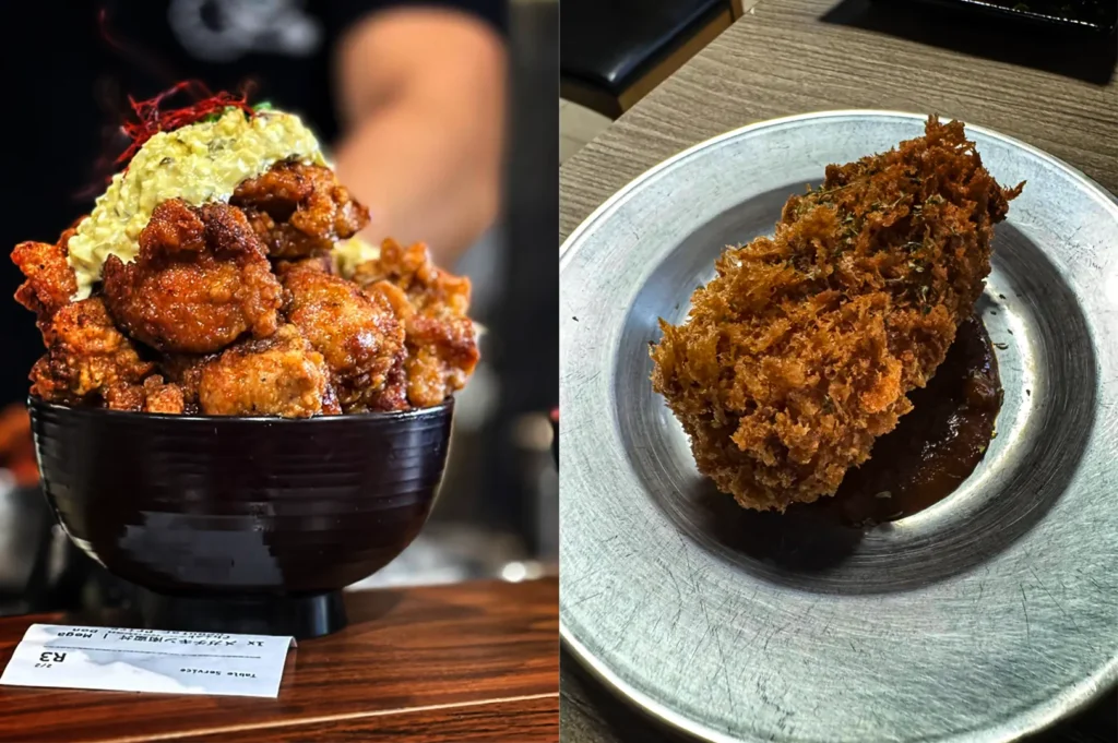 A split-screen composition showcases two appetizing Japanese dishes side by side, representing the file "3-Sakedokoro Eizaburo Singapore.webp". On the left, a close-up shot features a deep black bowl piled high with a towering mound of crispy, golden-brown chicken nanban, generously topped with a creamy, yellowish tartar sauce and a few strands of red chili filaments, resting on a wooden counter next to a white order slip. On the right, a high-angle shot presents a single, large, deeply fried cutlet or croquette with a highly textured, spiky panko crust, served on a dark pool of savory tonkatsu sauce inside a simple, circular metal plate on a wooden dining table.